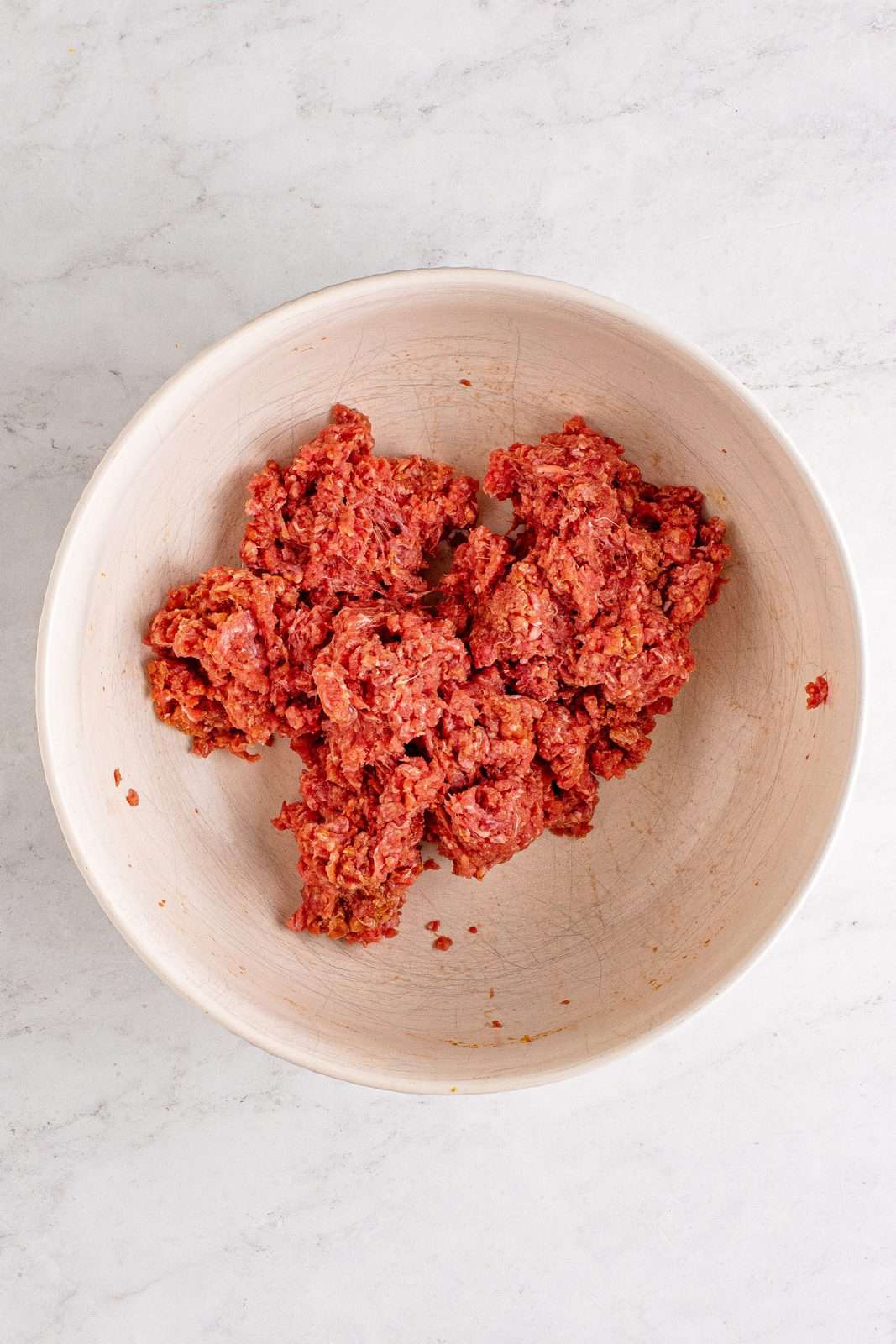 Ground beef mixed together in bowl.