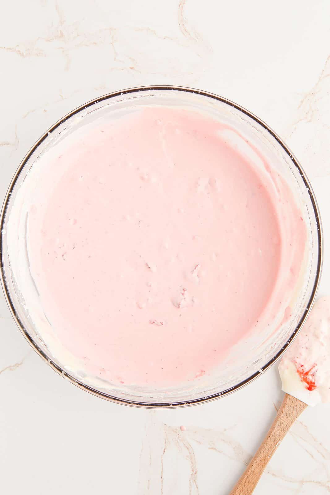 Sweetened condensed milk and mashed strawberries folded into the whipped cream.