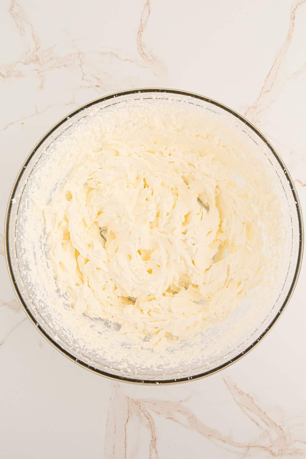 Heavy cream whipped in bowl.