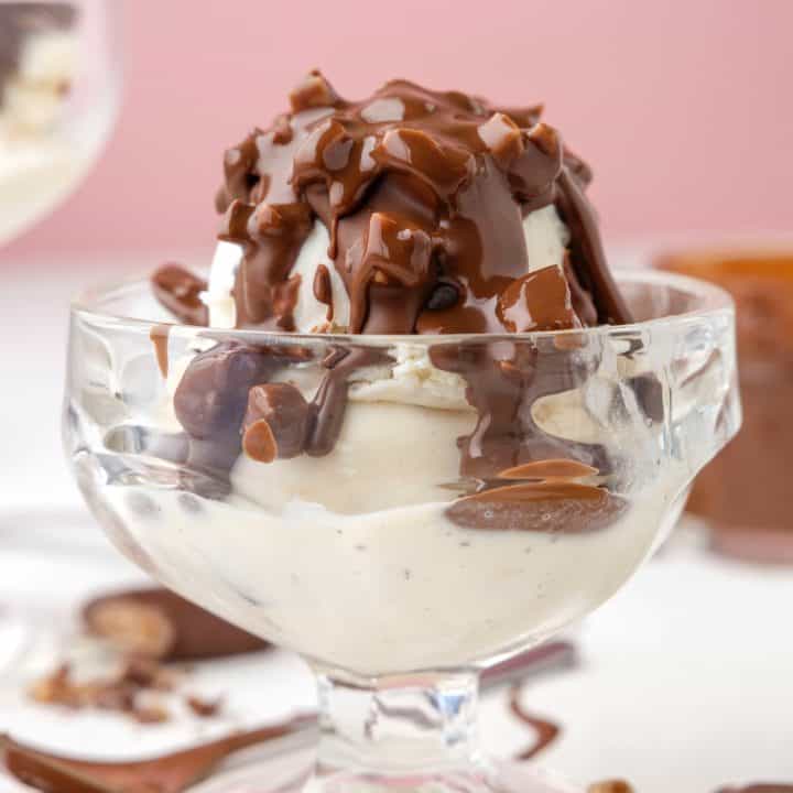 Square image close up of Heath Bar Magic Shell over ice cream in parfait cup.