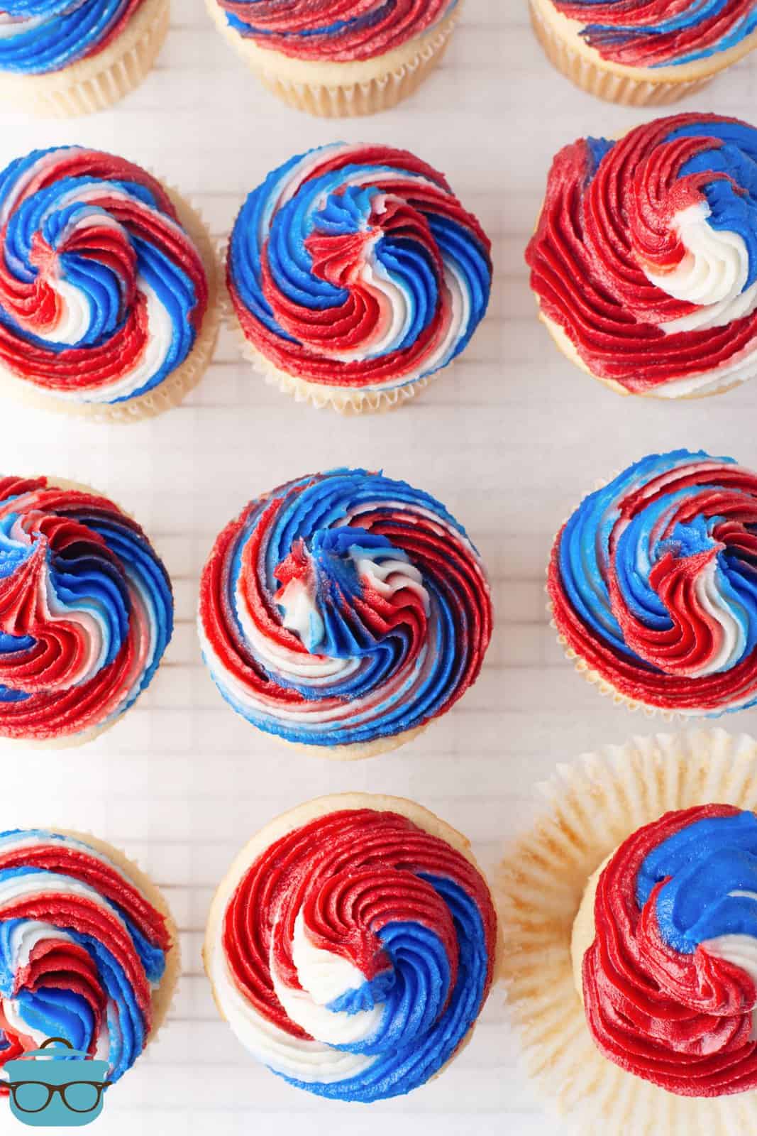 Overhead of 4th of July cupcakes on wire rack.