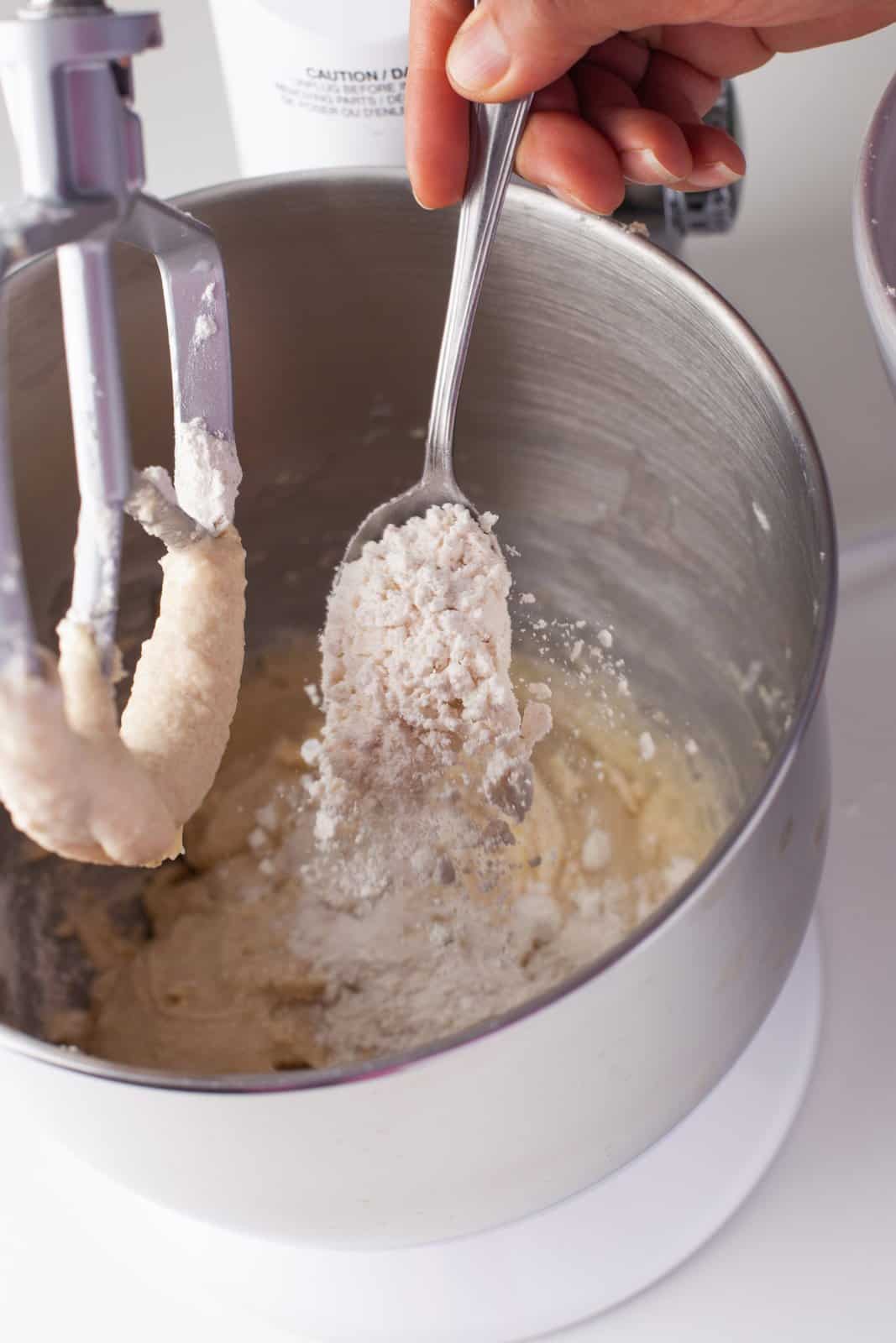 Gli ingredienti secchi setacciati vengono aggiunti al robot da cucina.