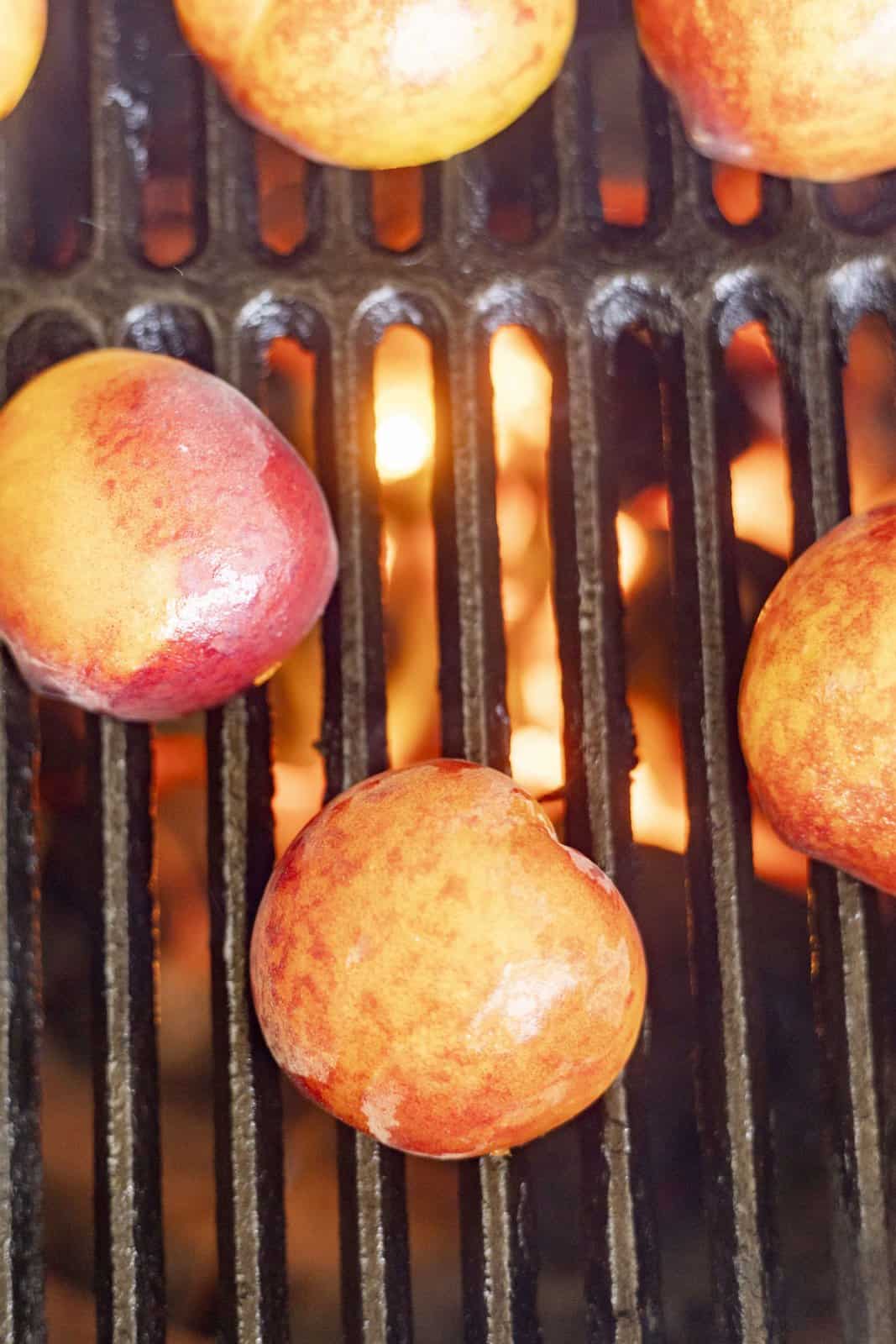 Cut side of peaches down on grill.