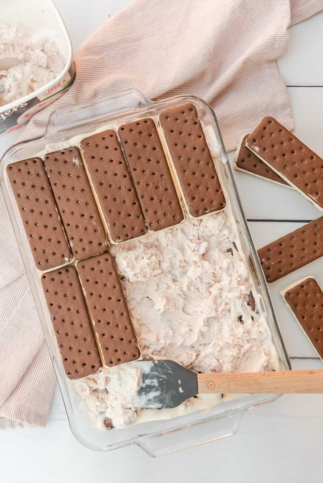 Second layer of ice cream sandwiches added to top of spread out ice cream.