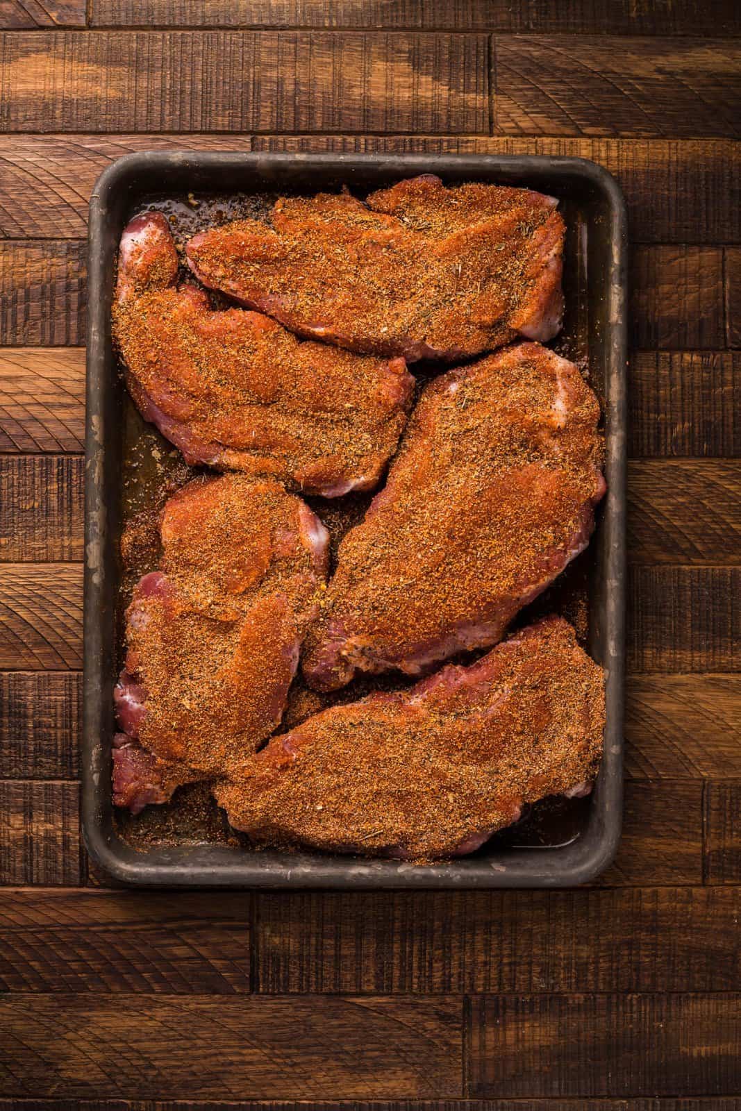 Pork Steaks rubbed with dry rub.