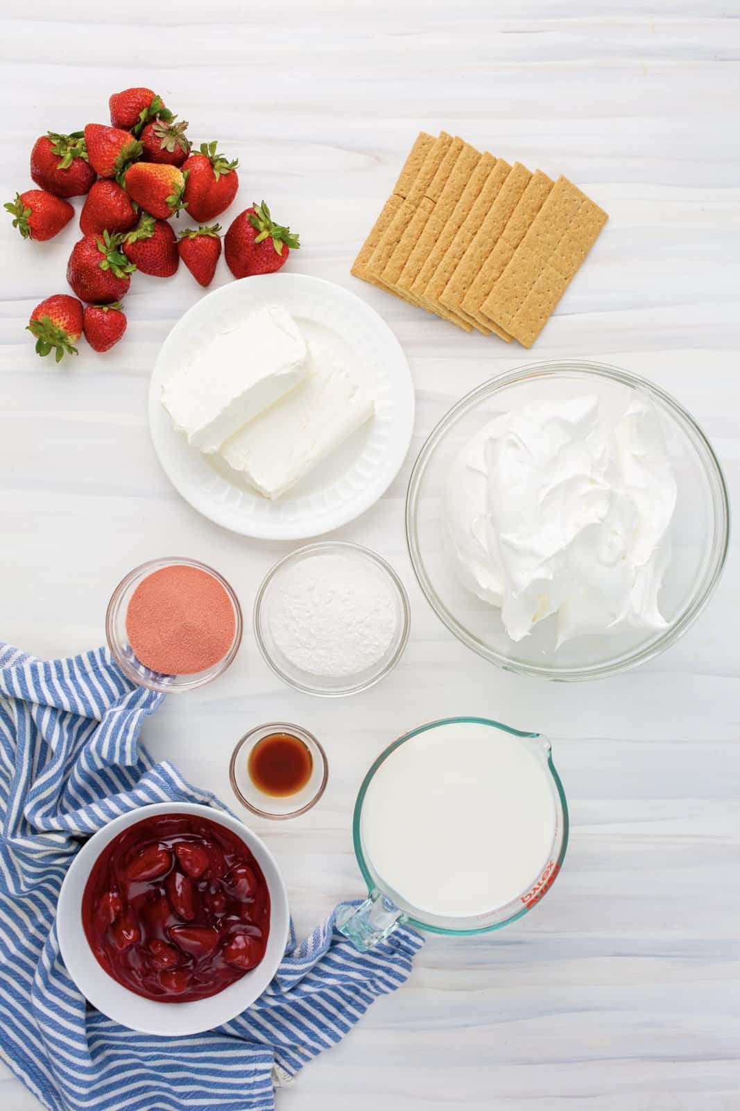 Ingredients needed: cream cheese, instant cheesecake jello pudding, strawberry jello, strawberries, cool whip, milk, vanilla extract, graham crackers and strawberry pie filling, optional.