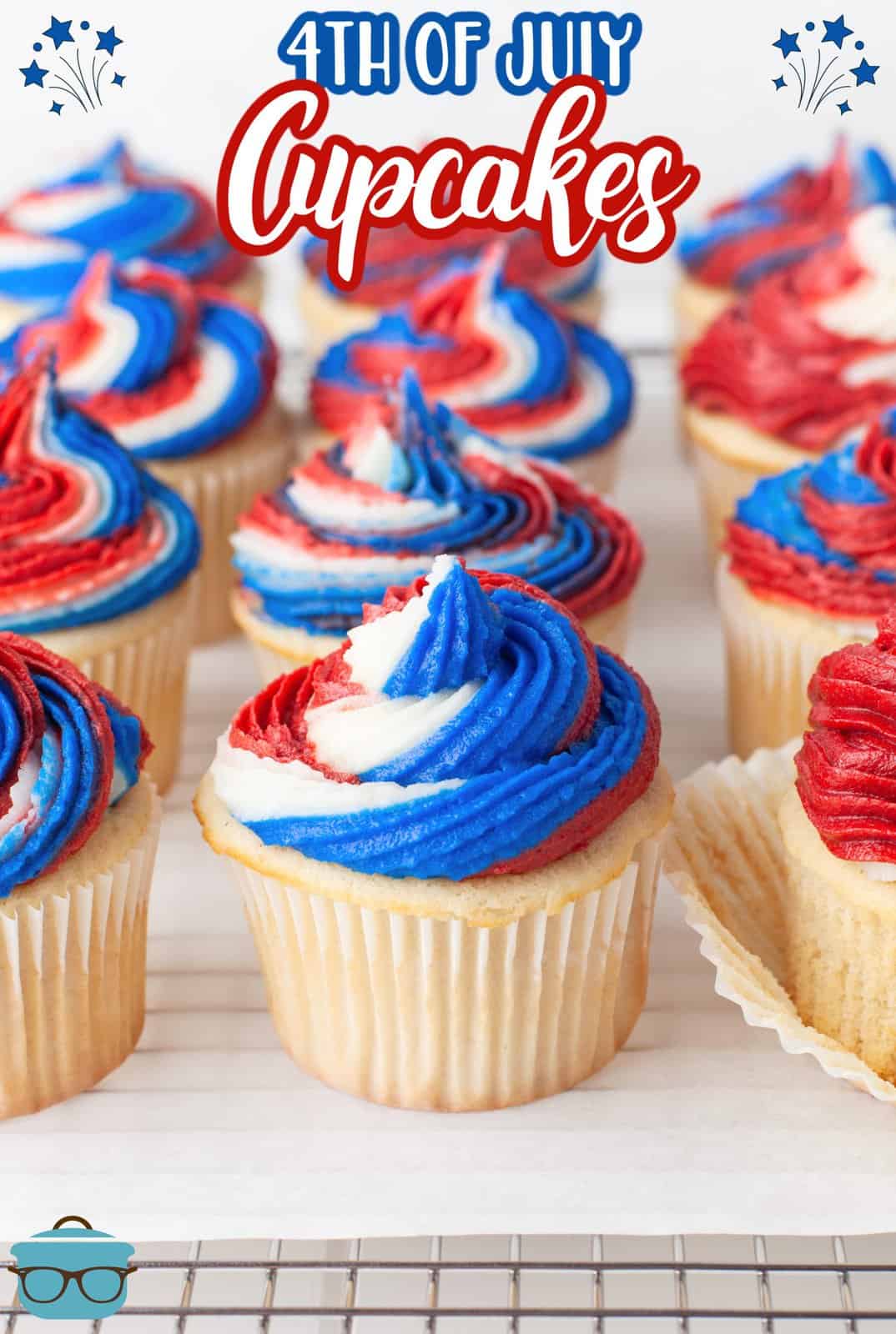 Pinterest image close up of 4th of July Cupcakes on parchment over wire rack in rows.