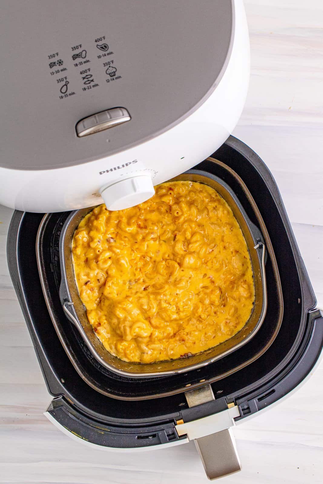 Stirred Mac and cheese mixture in air fryer.