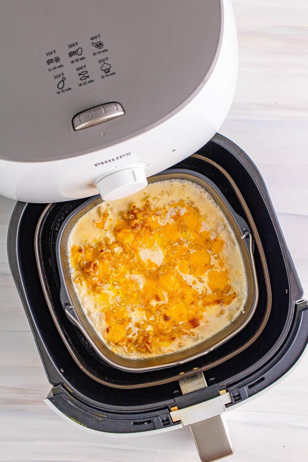 Mac and cheese pulled out of air fryer before stirring.