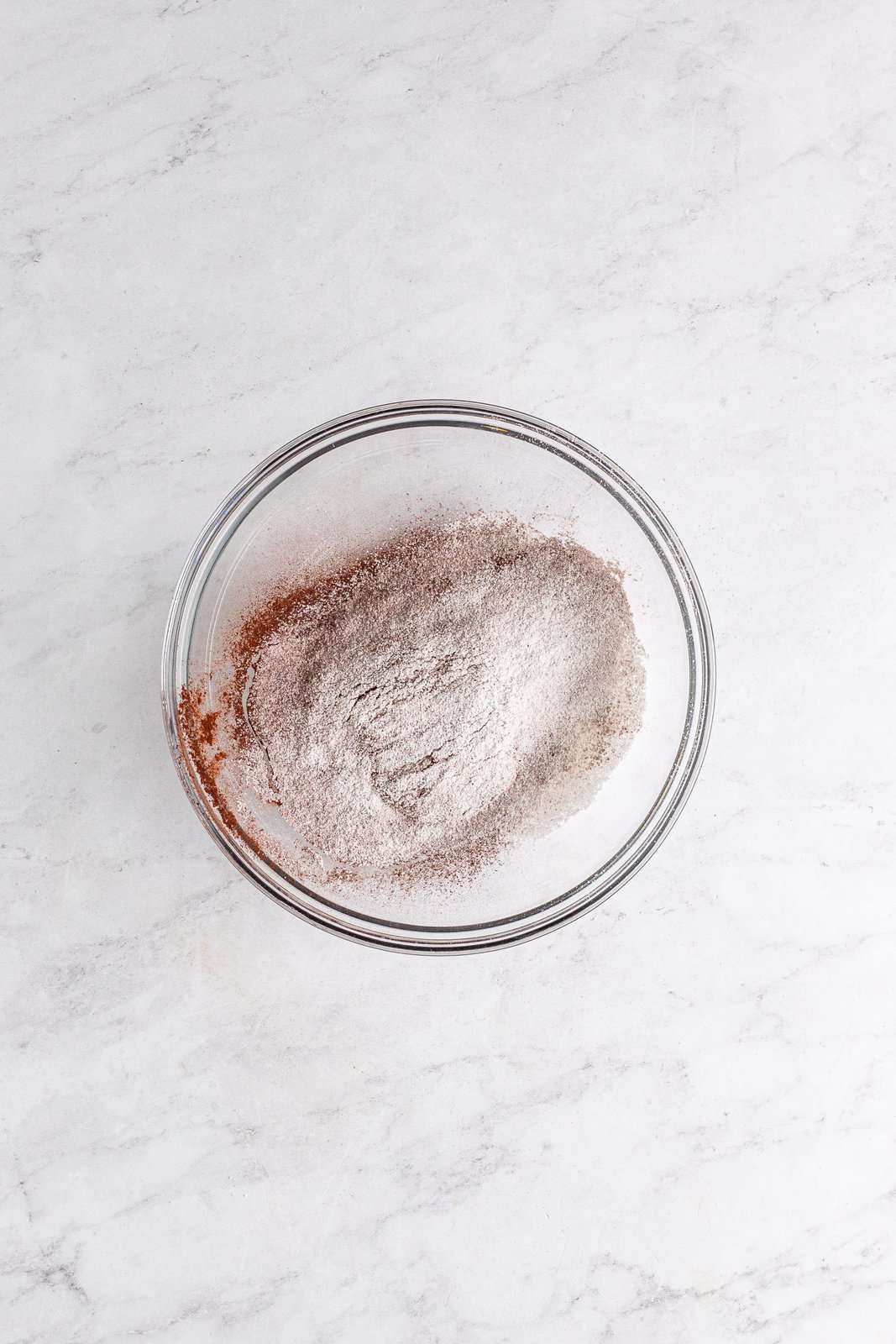 Sifted powdered sugar and cocoa powder in bowl.