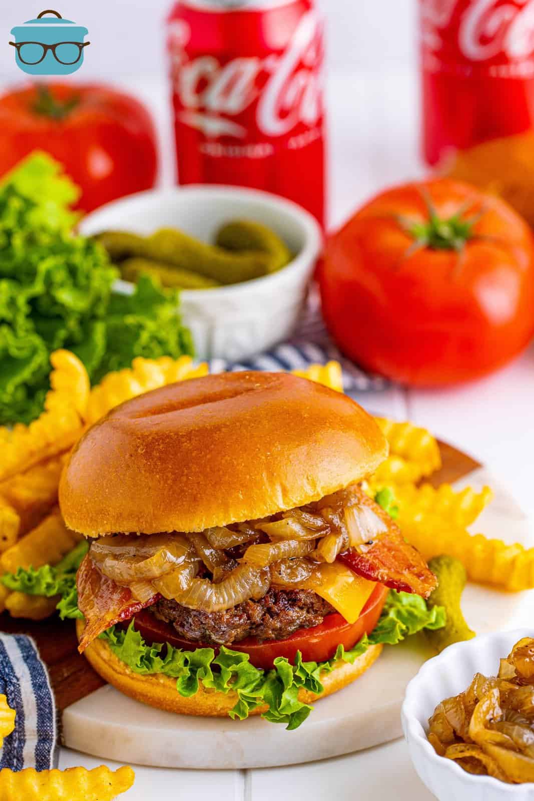 Grilled Bacon Cheeseburgers with Coca Cola Onions on plate with fries.