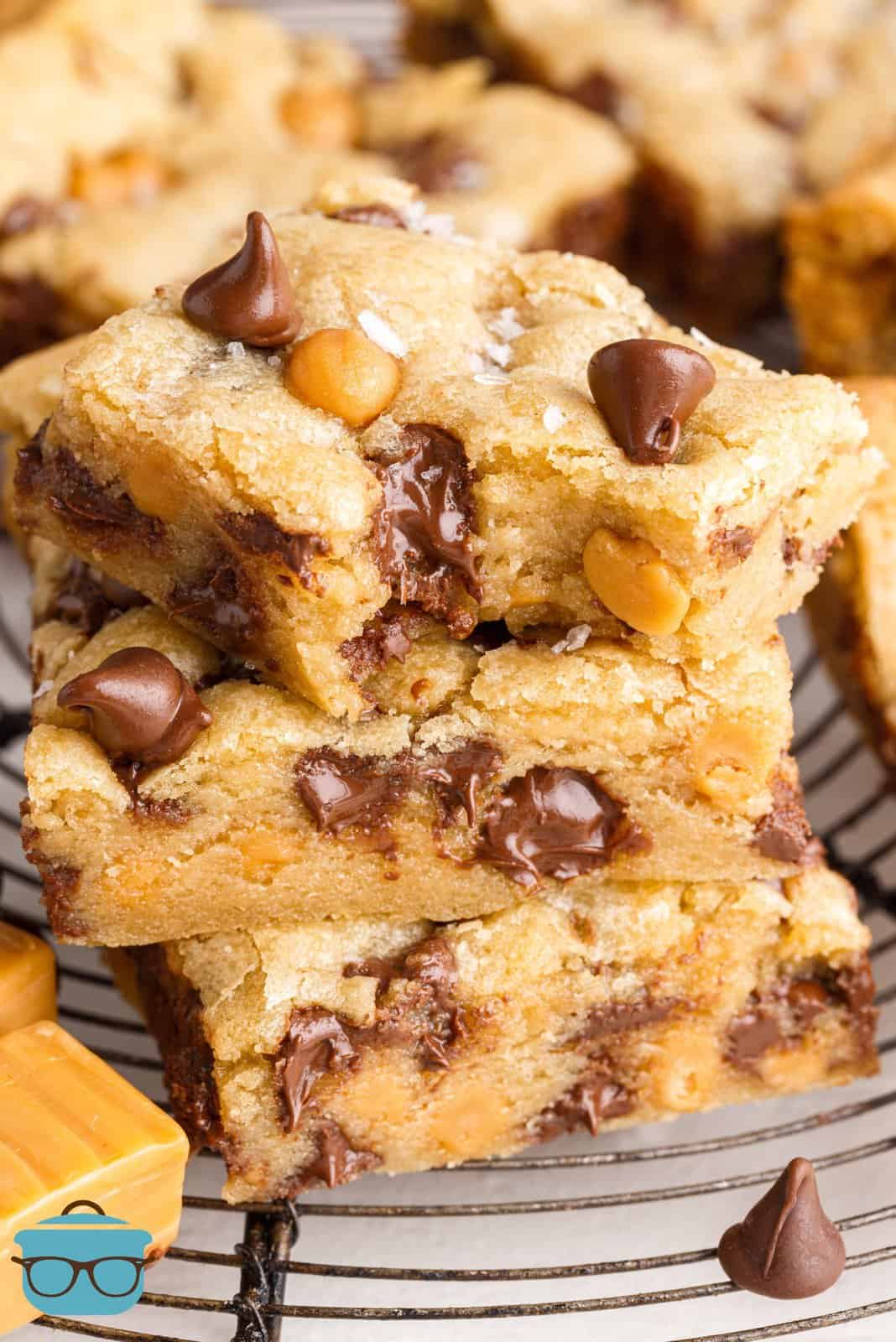 Stacked Salted Caramel Chocolate Chip Cookie Bars with bite taken out of top one.