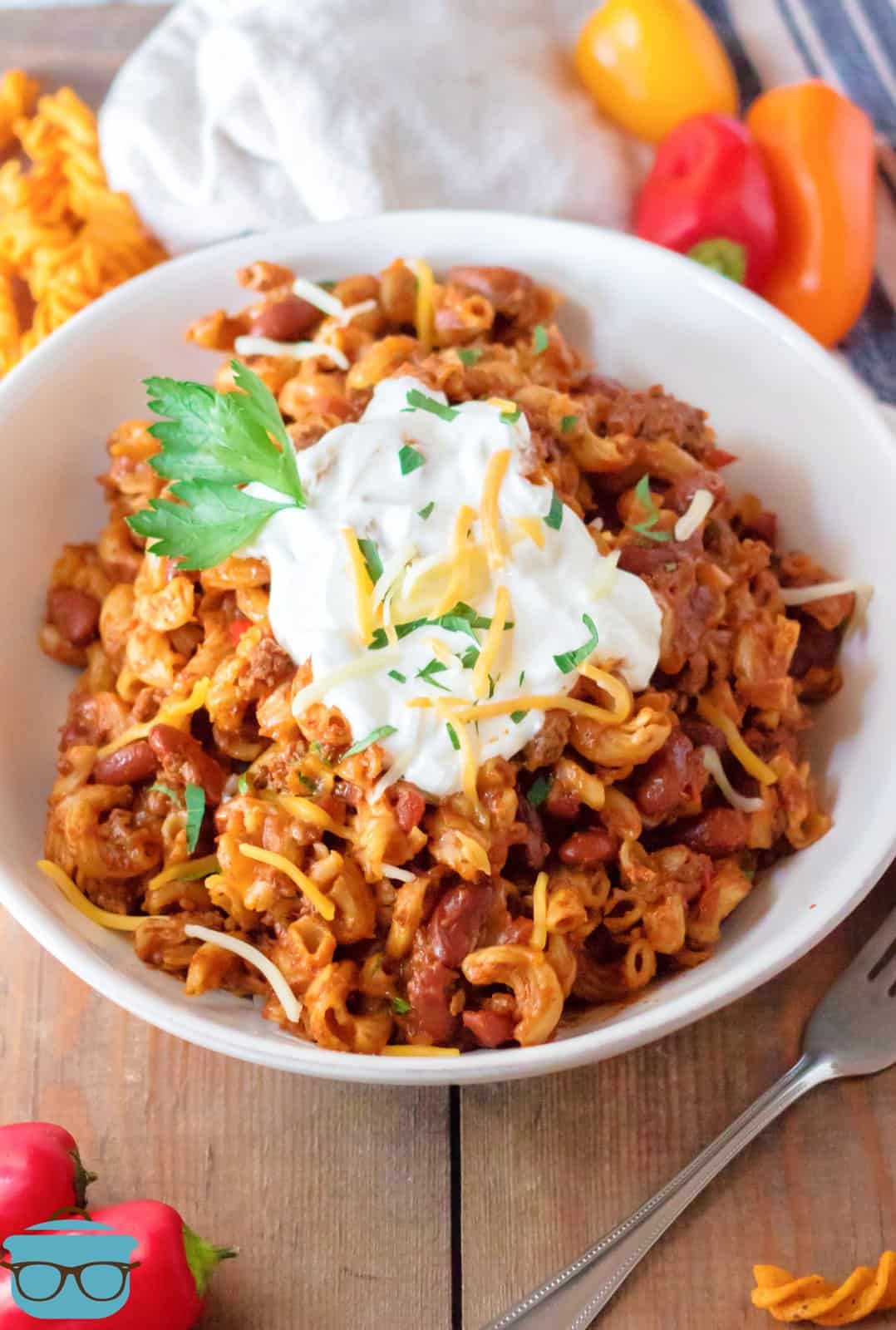 Slow Cooker Chili Mac in bowl topped with sour cream.