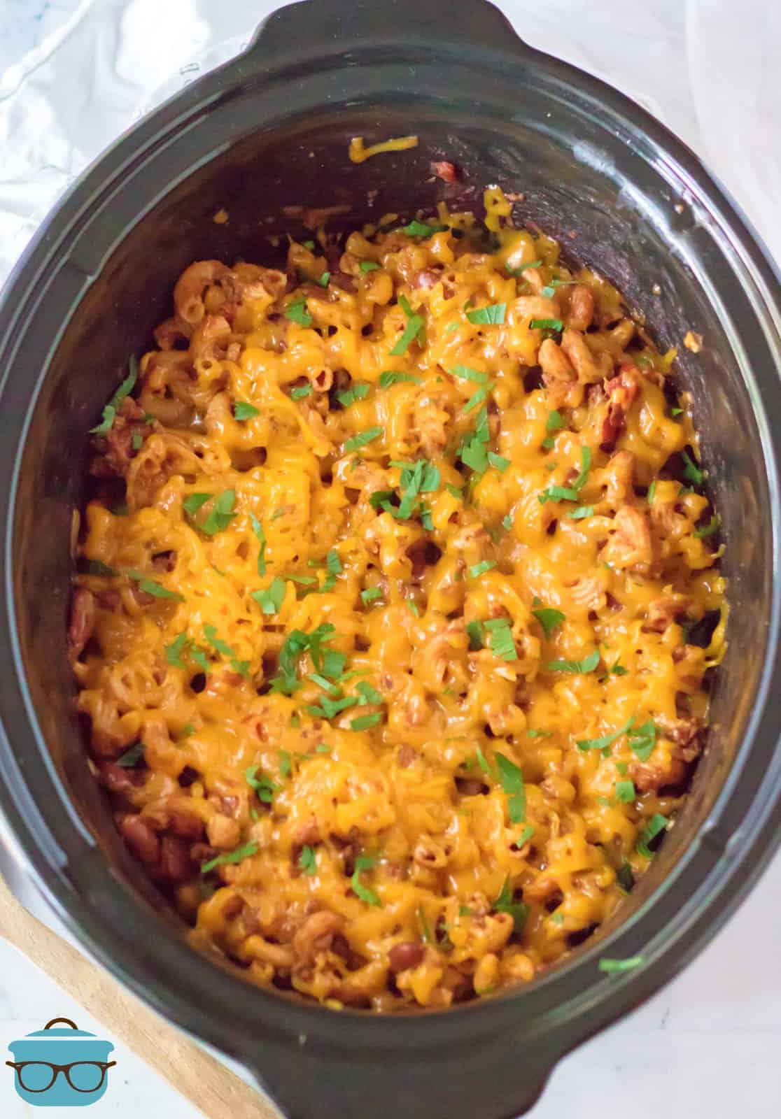 Finished Slow Cooker Chili Mack in crock pot with melted cheese and parsley.
