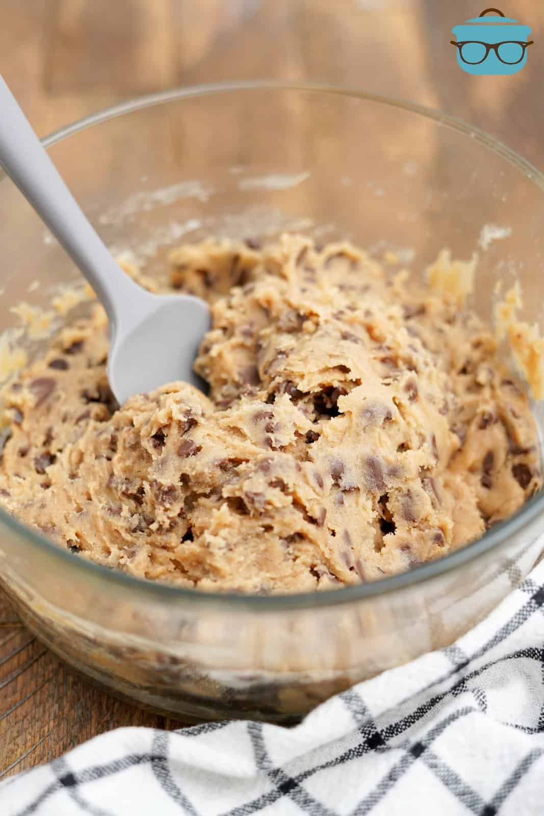Bowl of Edible Chocolate Chip Cookie dough with spatula in it.