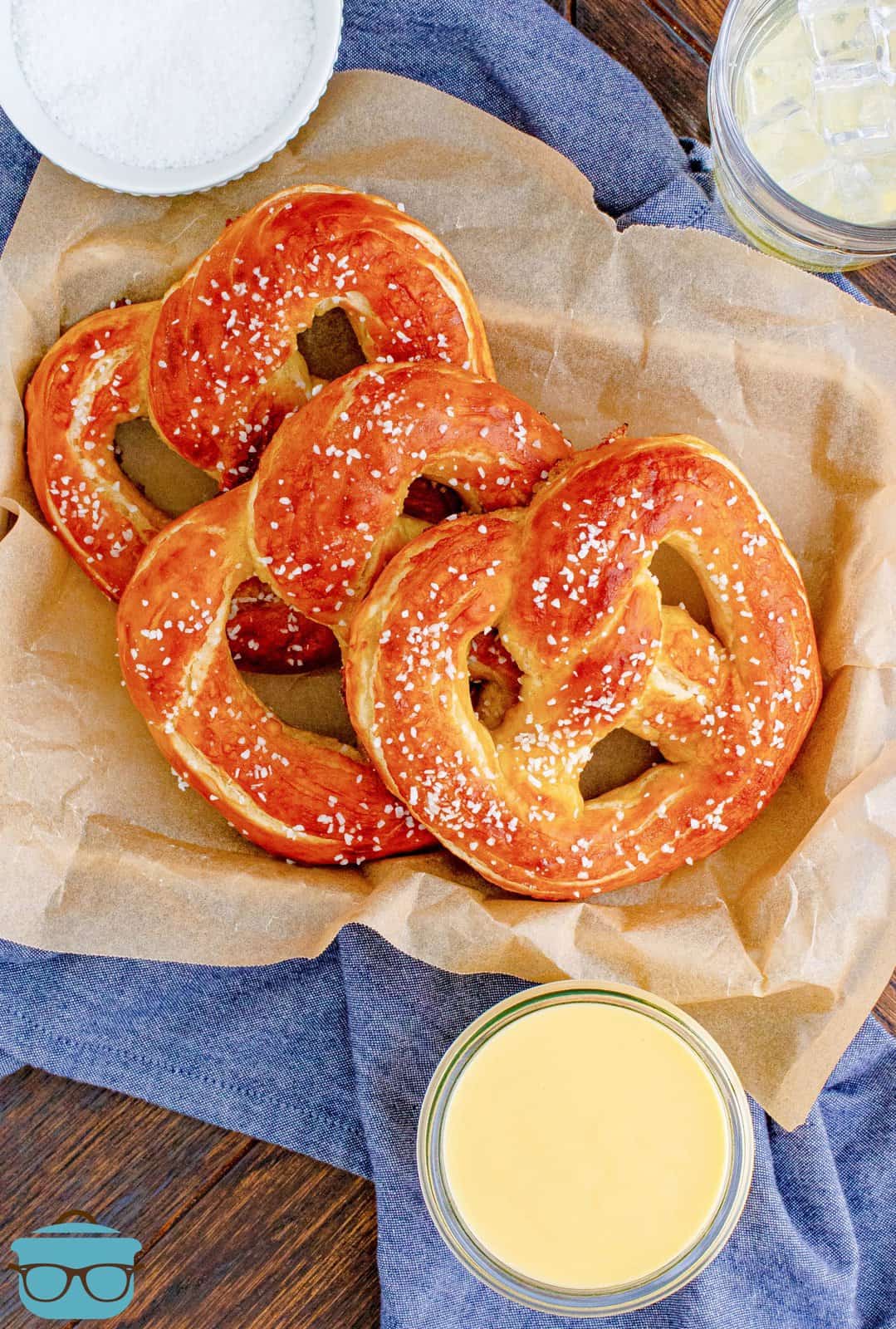 Overhead of three Homemade Soft Pretzels layered in parchment lined tray.