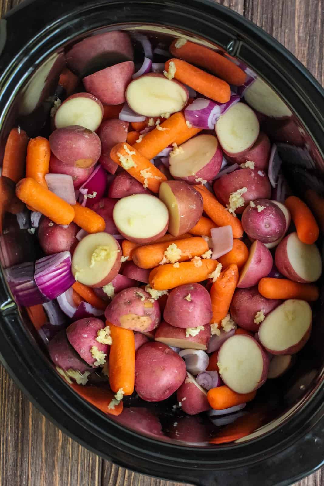 Vegetables added to slow cooker.