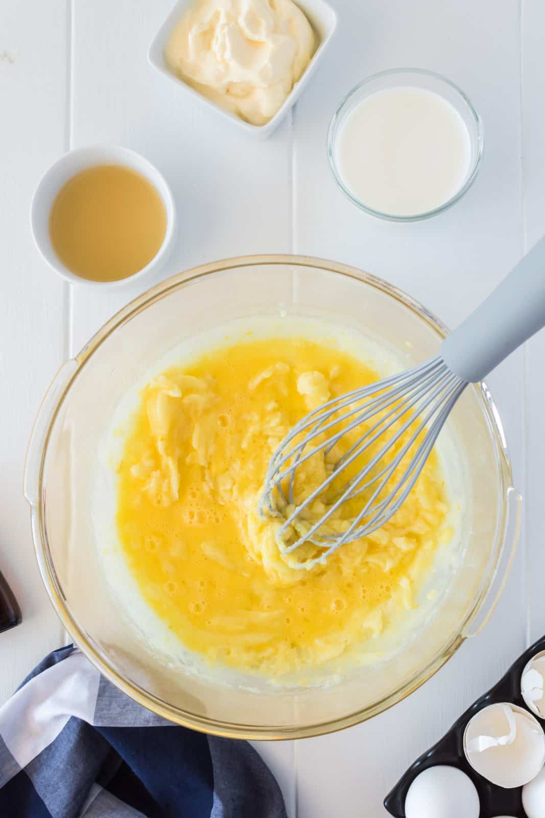 Butter, ggs, lemon juice, milk, yogurt, and almond extract whisked into the sugar mixture.