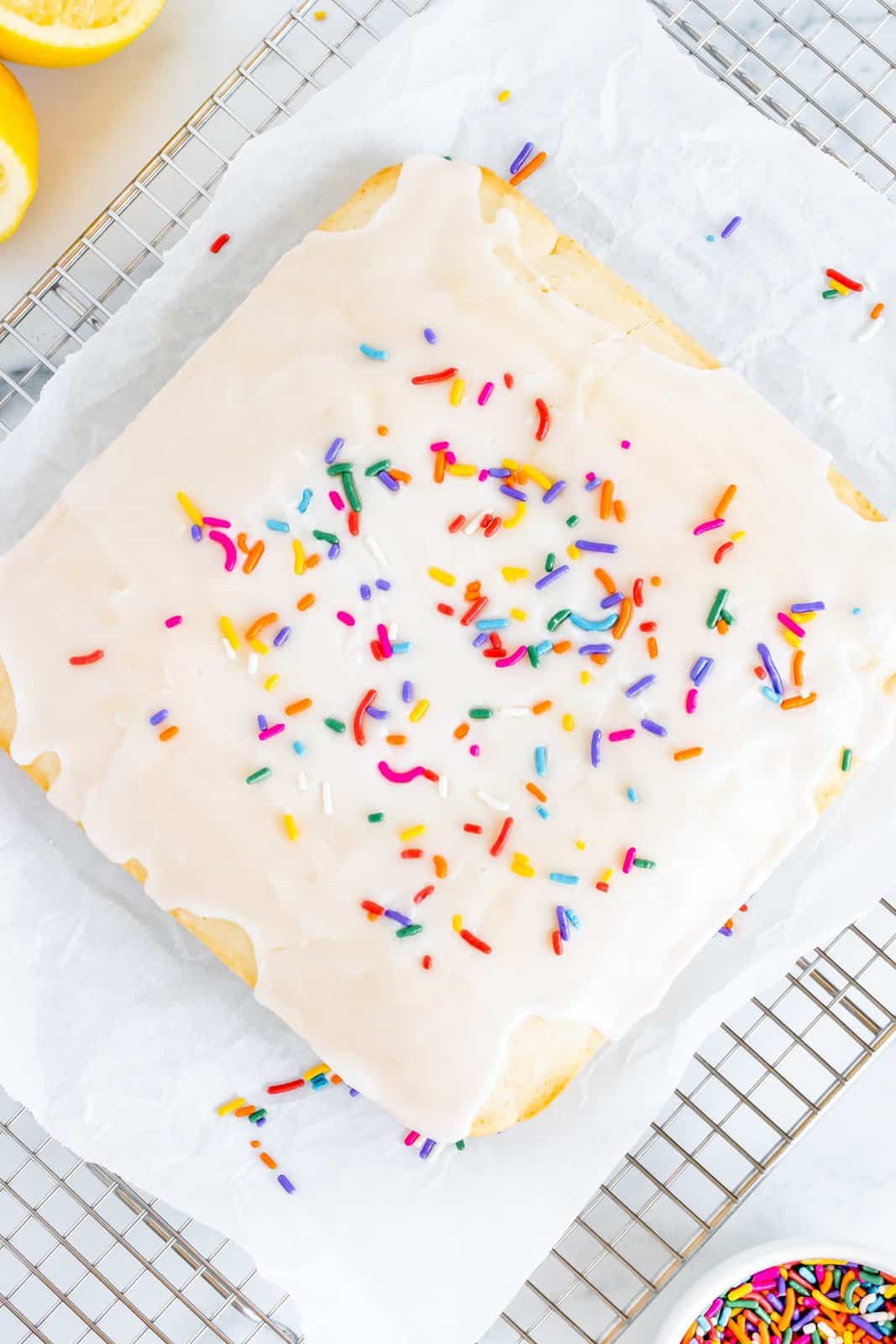 Glaze poured over cake and topped with sprinkles.