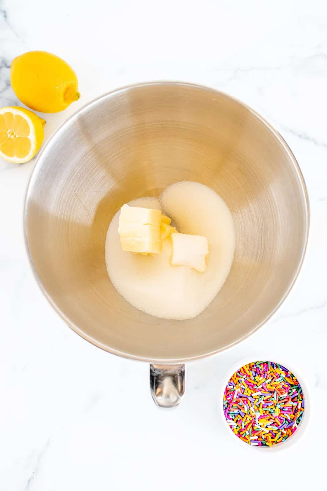 Butter and sugar in bowl of stand mixer.