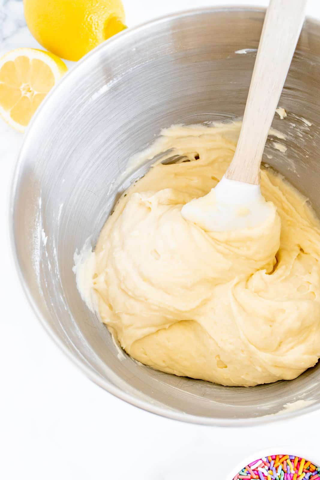 Cake batter mixed together in bowl of stand mixer.