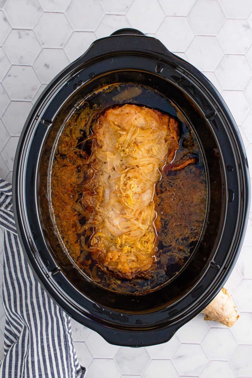 Finished pork loin in crock pot with gravy.