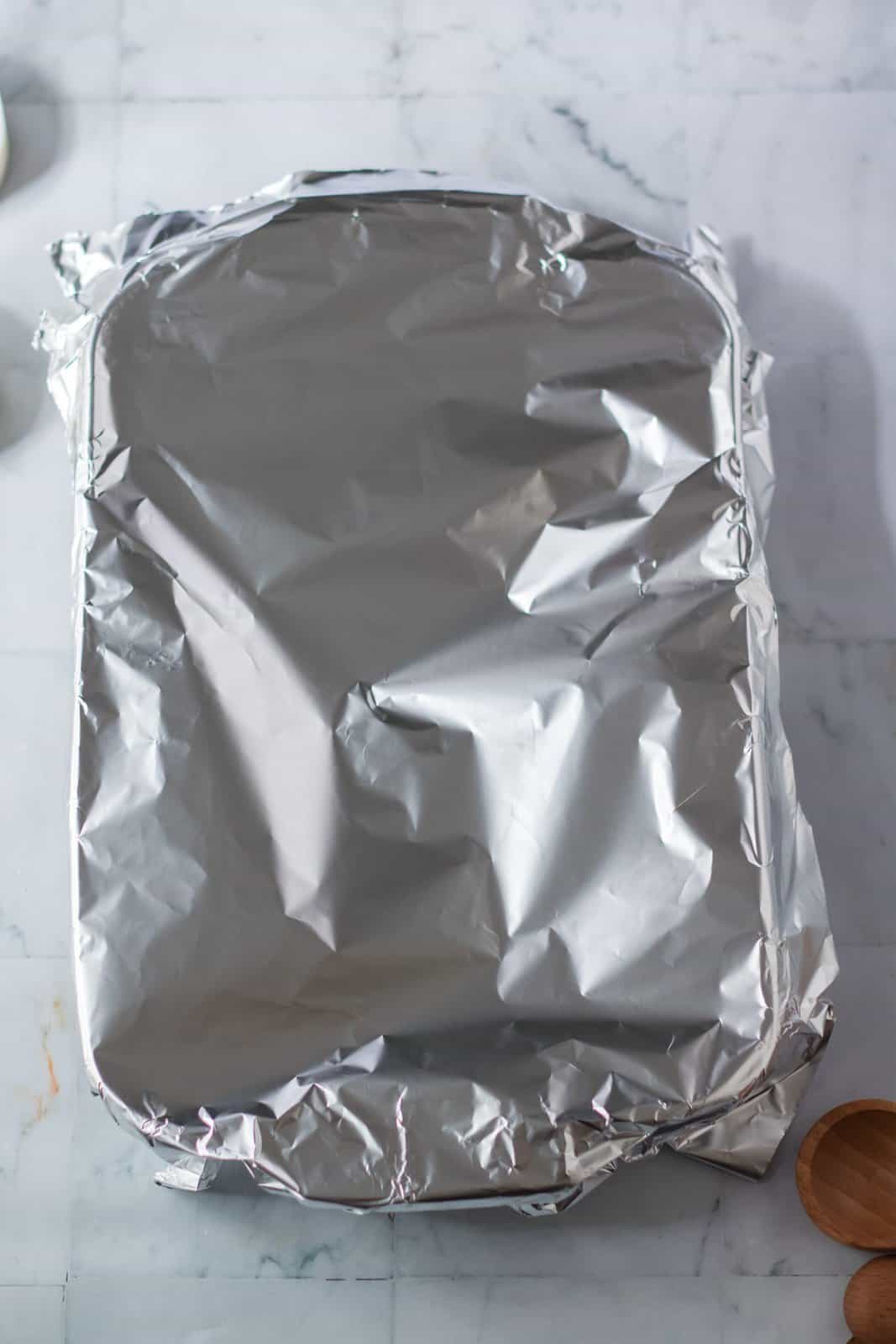 Pan covered with foil ready to be baked.