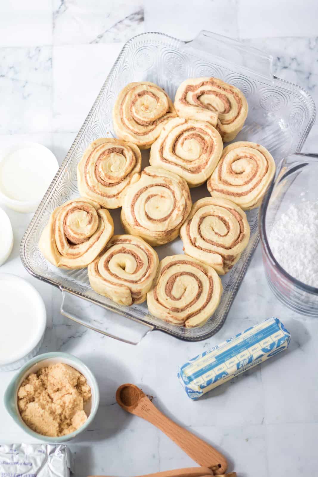 Ingredients needed: refrigerated grands cinnamon rolls, heavy whipping cream, butter, brown sugar, cinnamon, cream cheese and powdered sugar.