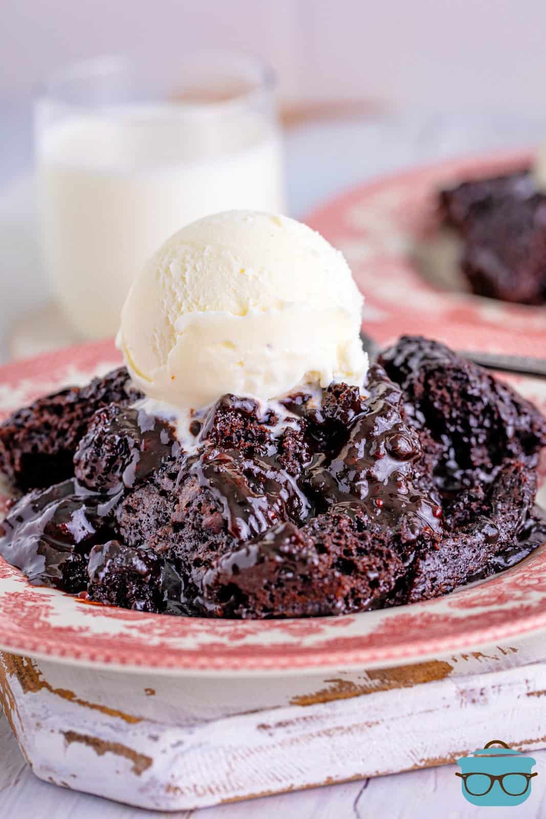 Hot Fudge Chocolate Cake on pink plate topped with ice cream.
