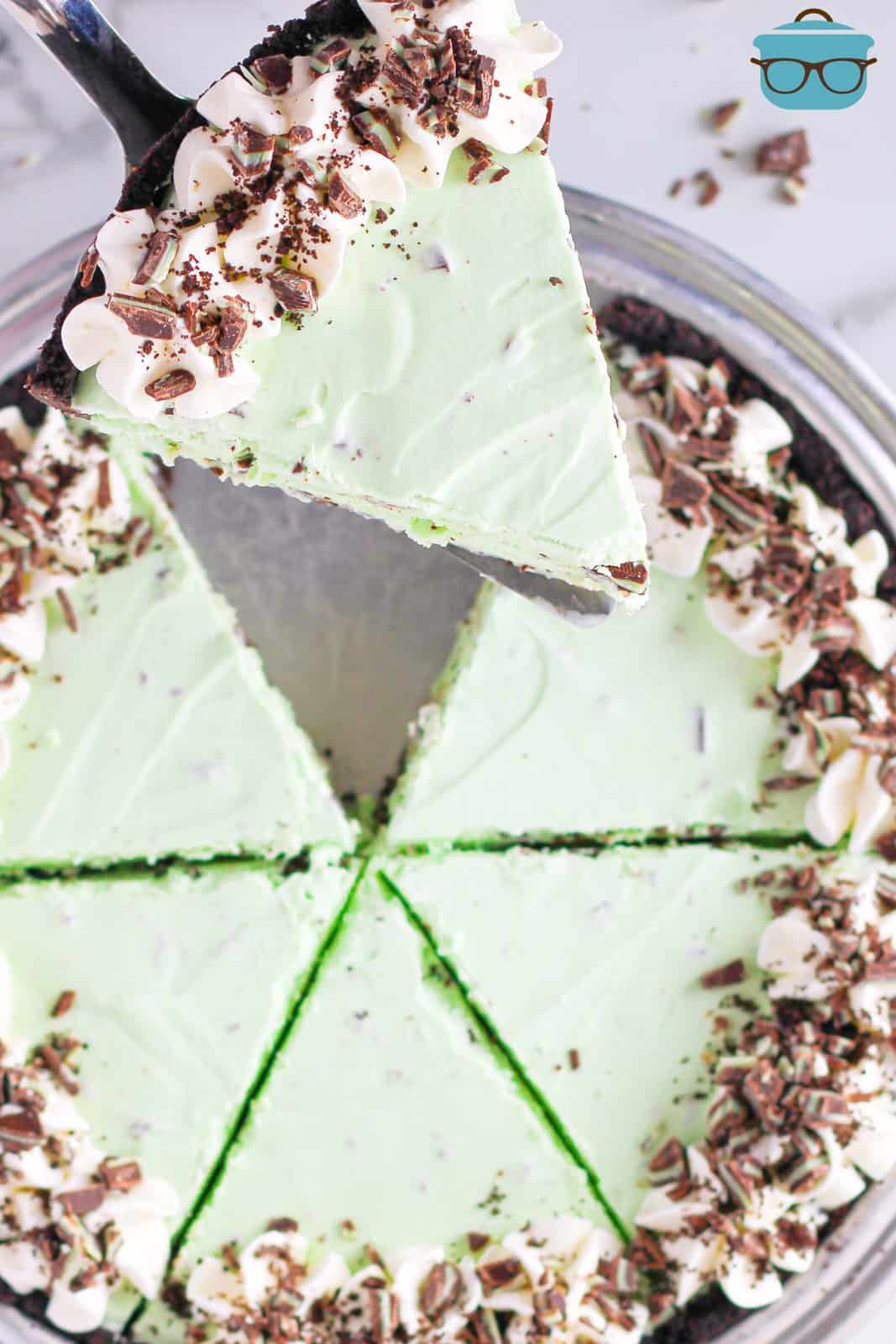 Overhead of sliced Mint Chip Ice Cream Pie with pie server holding up one piece.