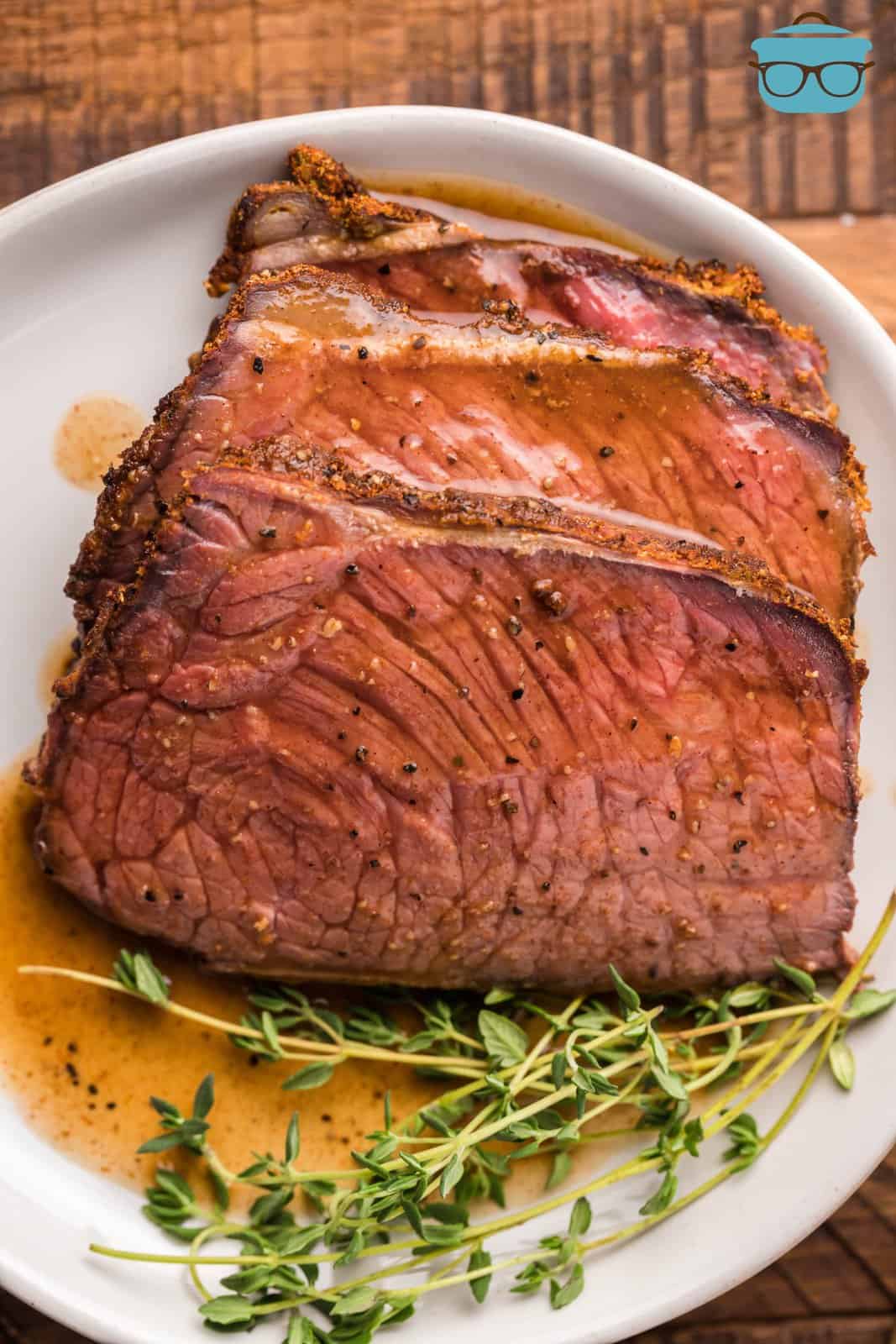 Overhead photo of slices of Smoked Rump Roast on plate with sauce.