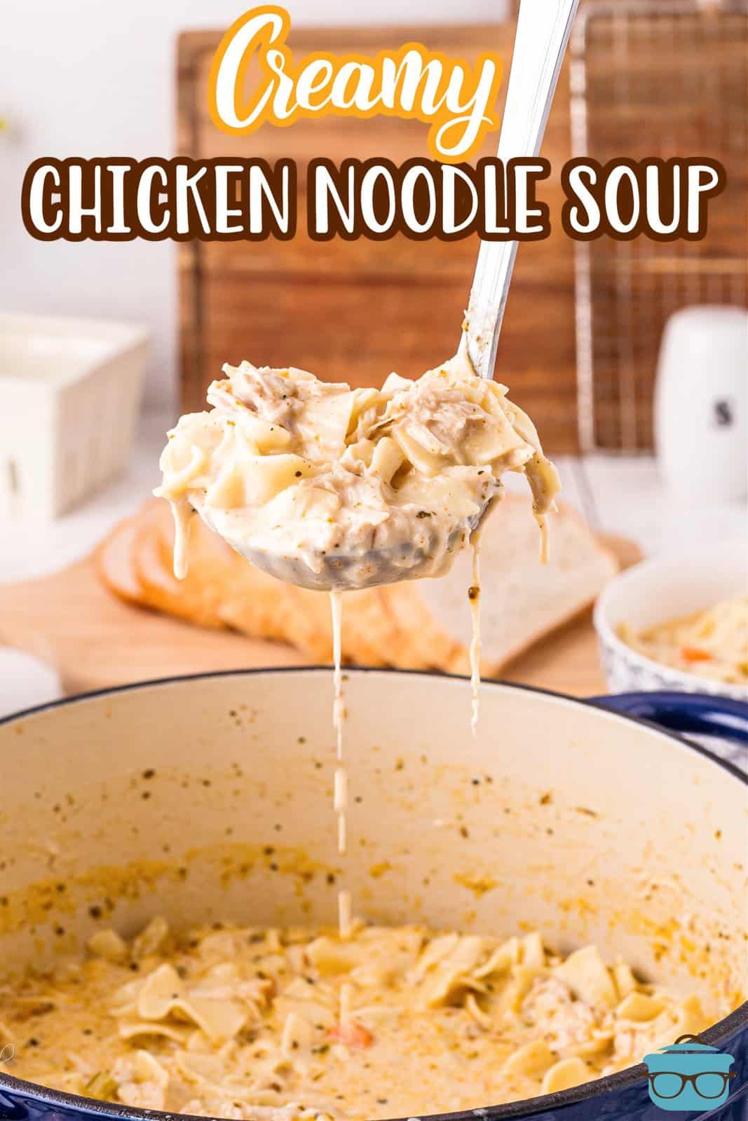 Pinterest image of Creamy Chicken Noodle Soup being lifted up by ladle.