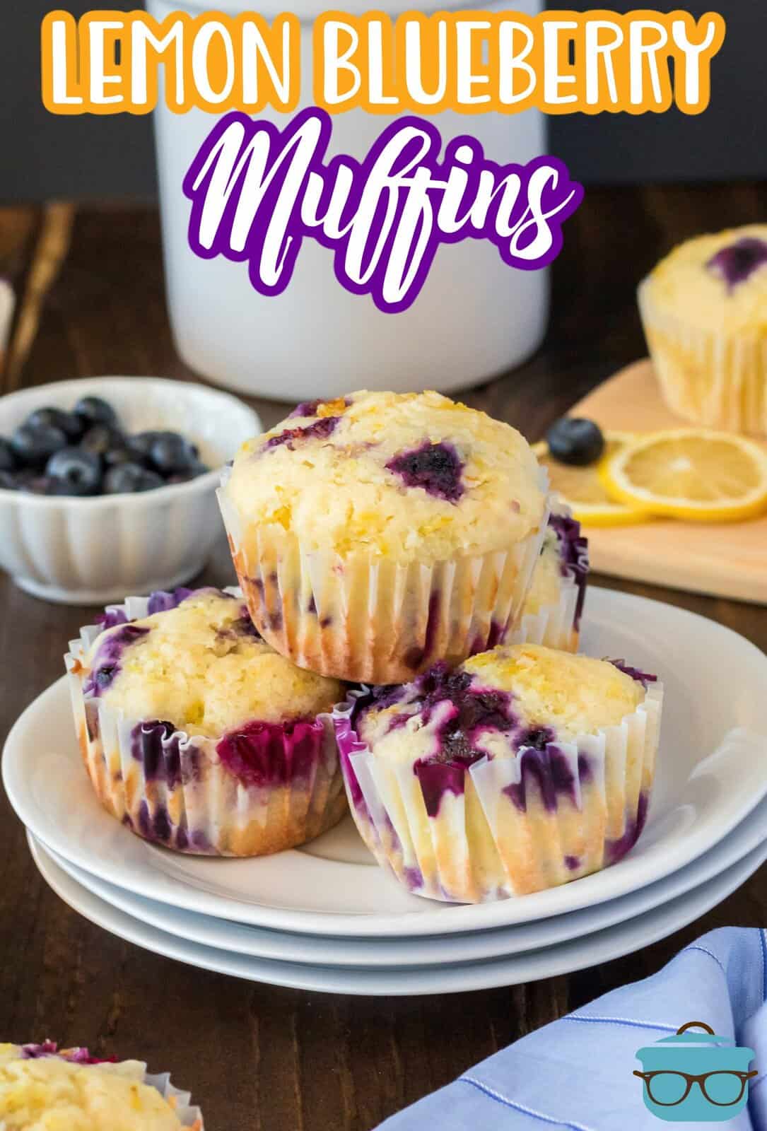 Stacked Lemon Blueberry Muffins on white plate.
