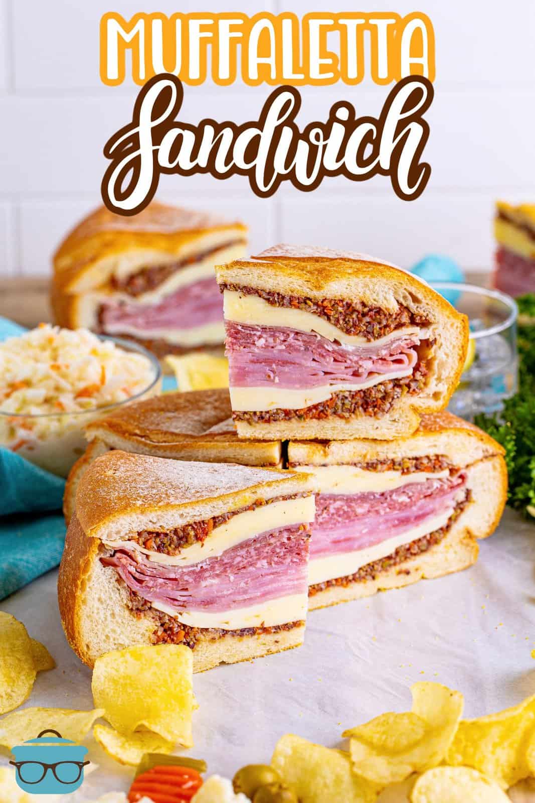 Stacked slices of the Muffaletta Sandwich on board, Pinterest image.