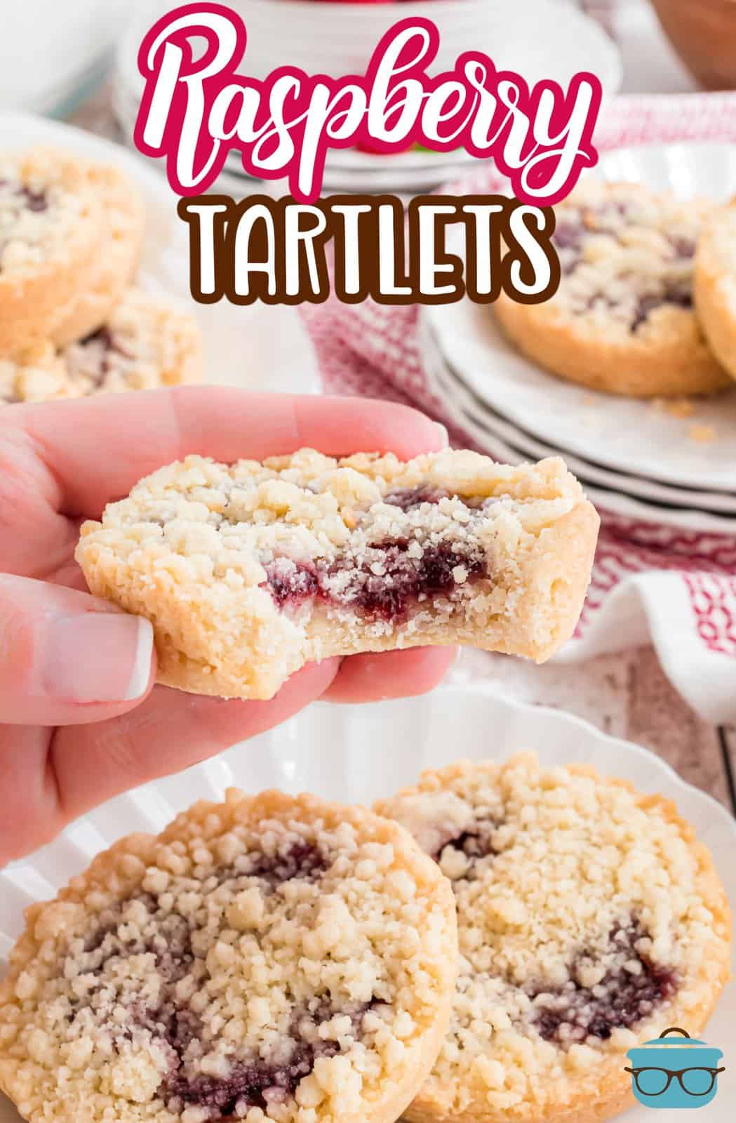 Pinterest image of hand holding up one Raspberry Tartlet with bite taken out of it.