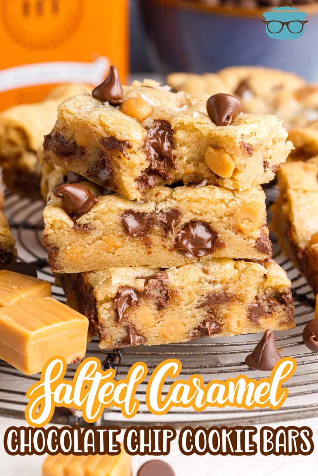 Pinterest image of three stacked Salted Caramel Chocolate Chip Cookie Bars with bite taken out of top one.