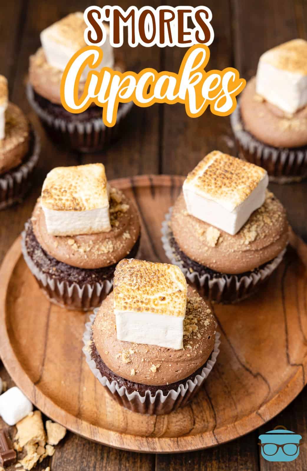 Overhead of S'mores Cupcakes on wooden board with some in background, Pinterest image.