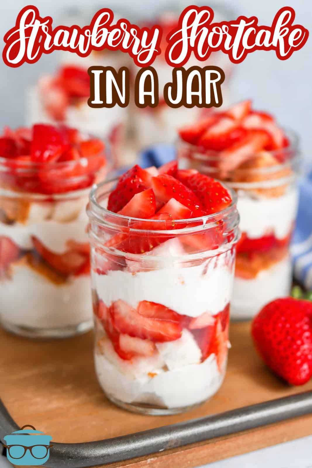 Pinterest image of multiple Strawberry Shortcake in a Jar on wooden platter.
