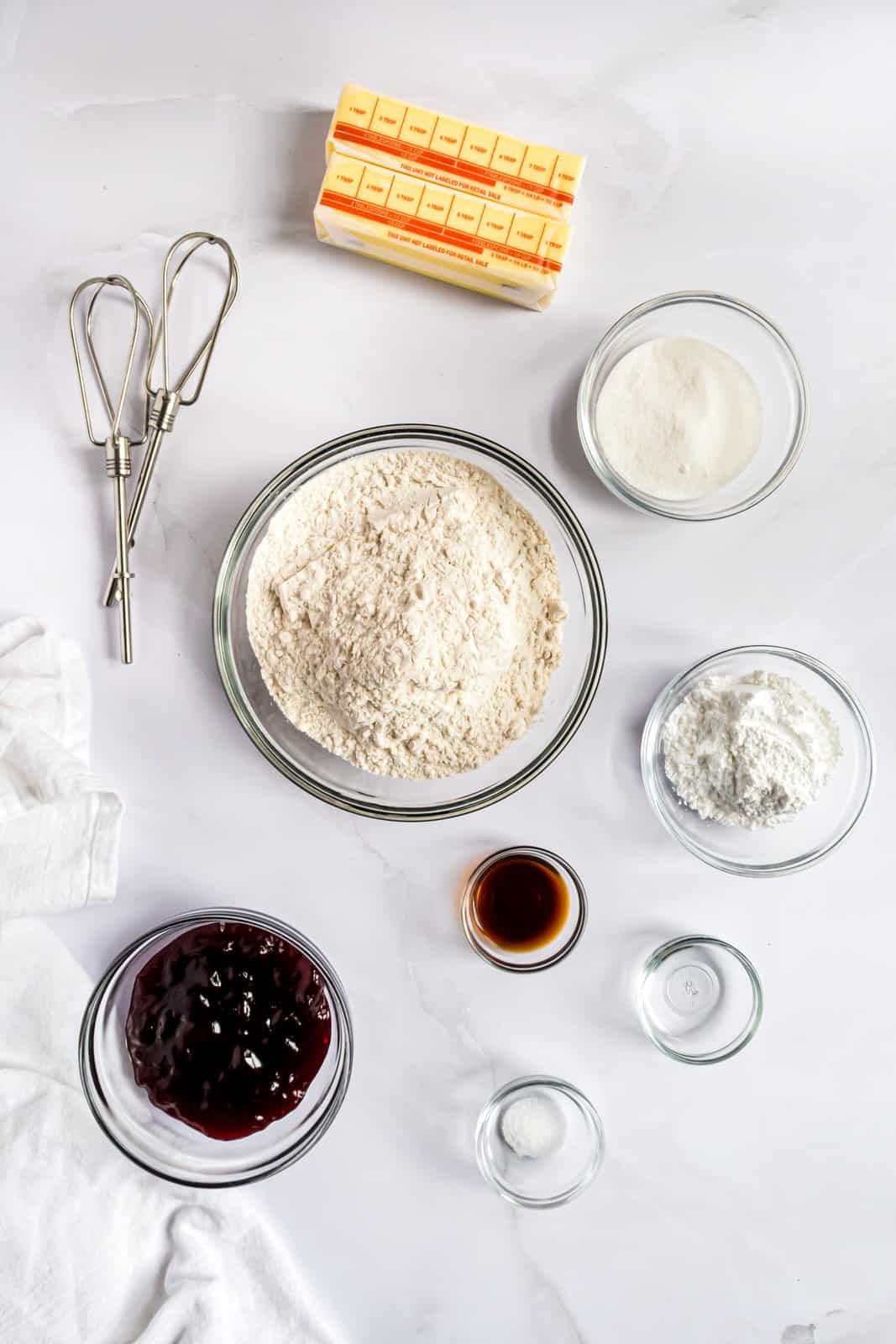 Ingredients needed:unsalted butter, granulated sugar, powdered sugar, vanilla extract, almond extract, all purpose flour, kosher salt and seedless raspberry jam.