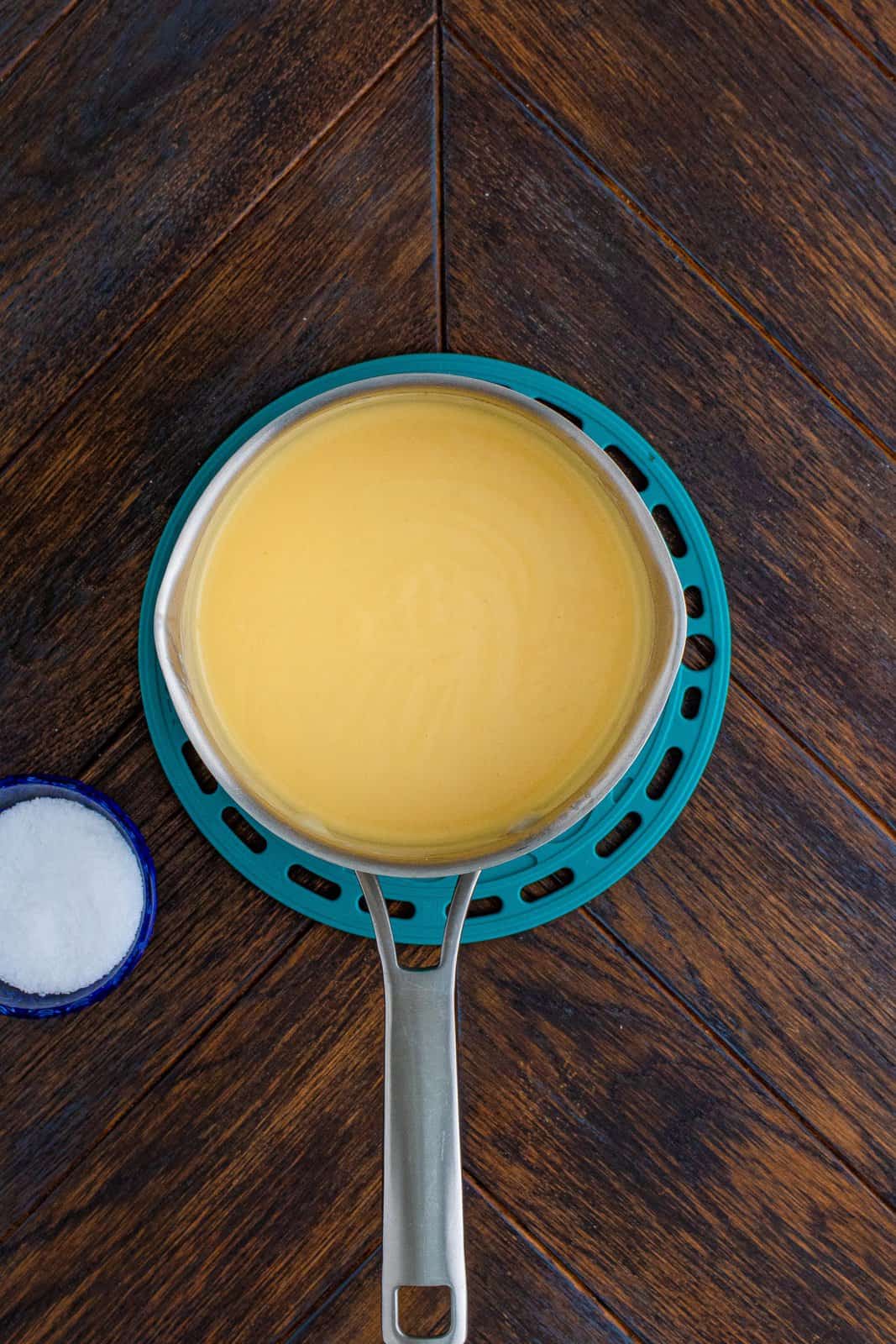 Cheese whisked into sauce pan until melted.