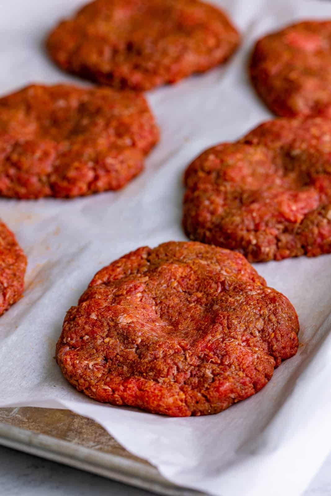 Burgers formed into patties with indent in the middle.