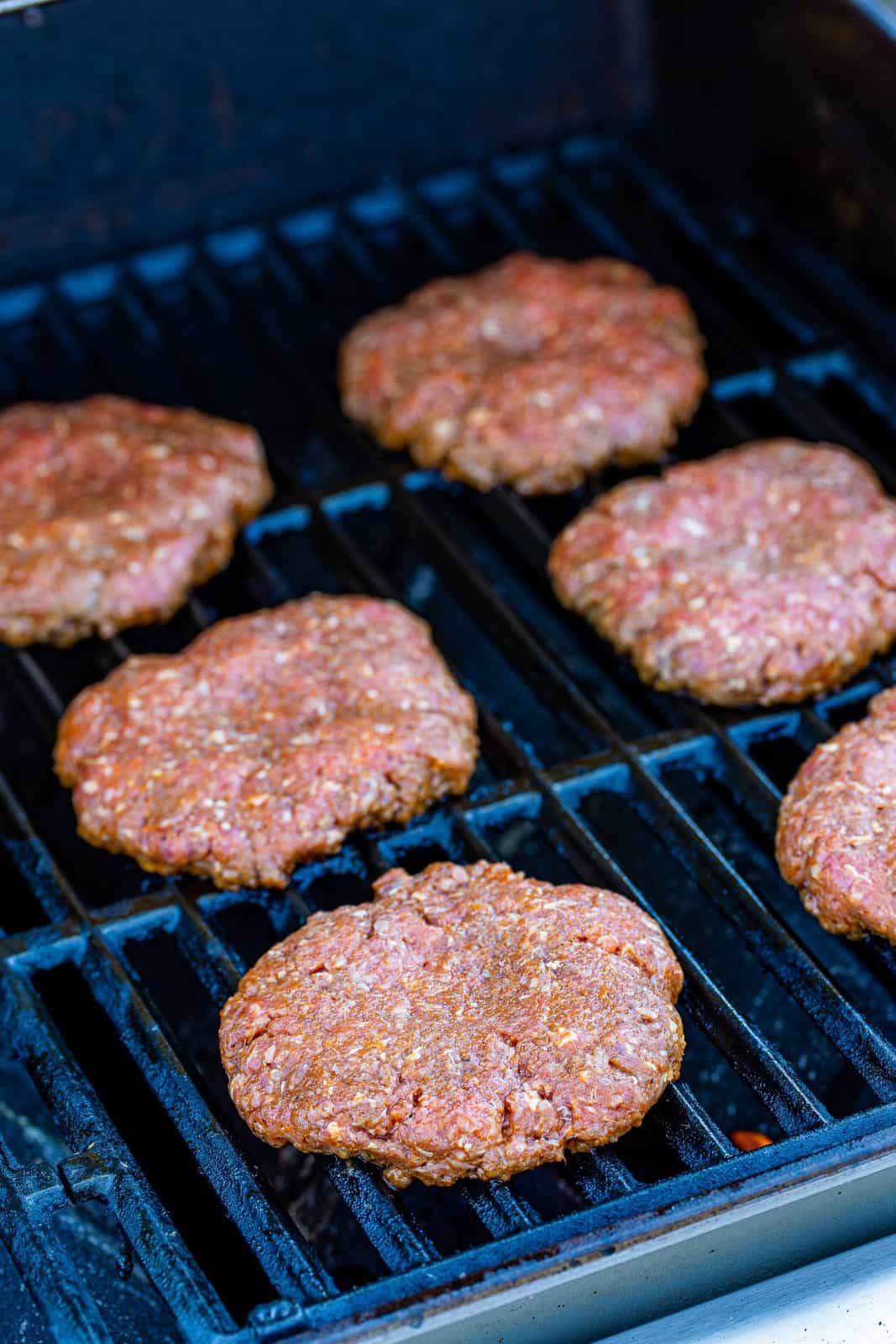 Burgers placed on grill.