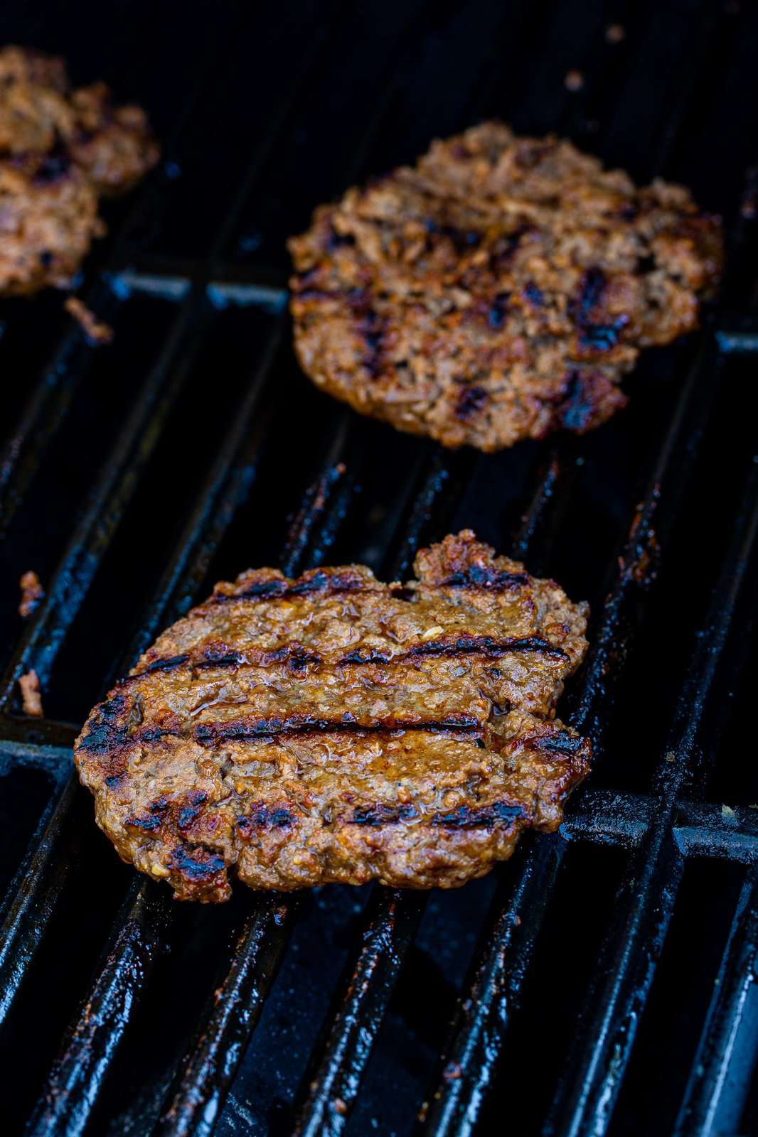 Burgers finished cooking on grill.