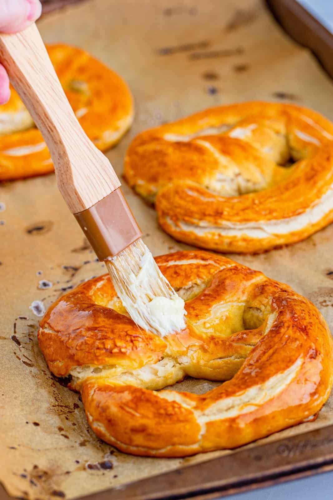 Finished pretzels being brushed with butter.