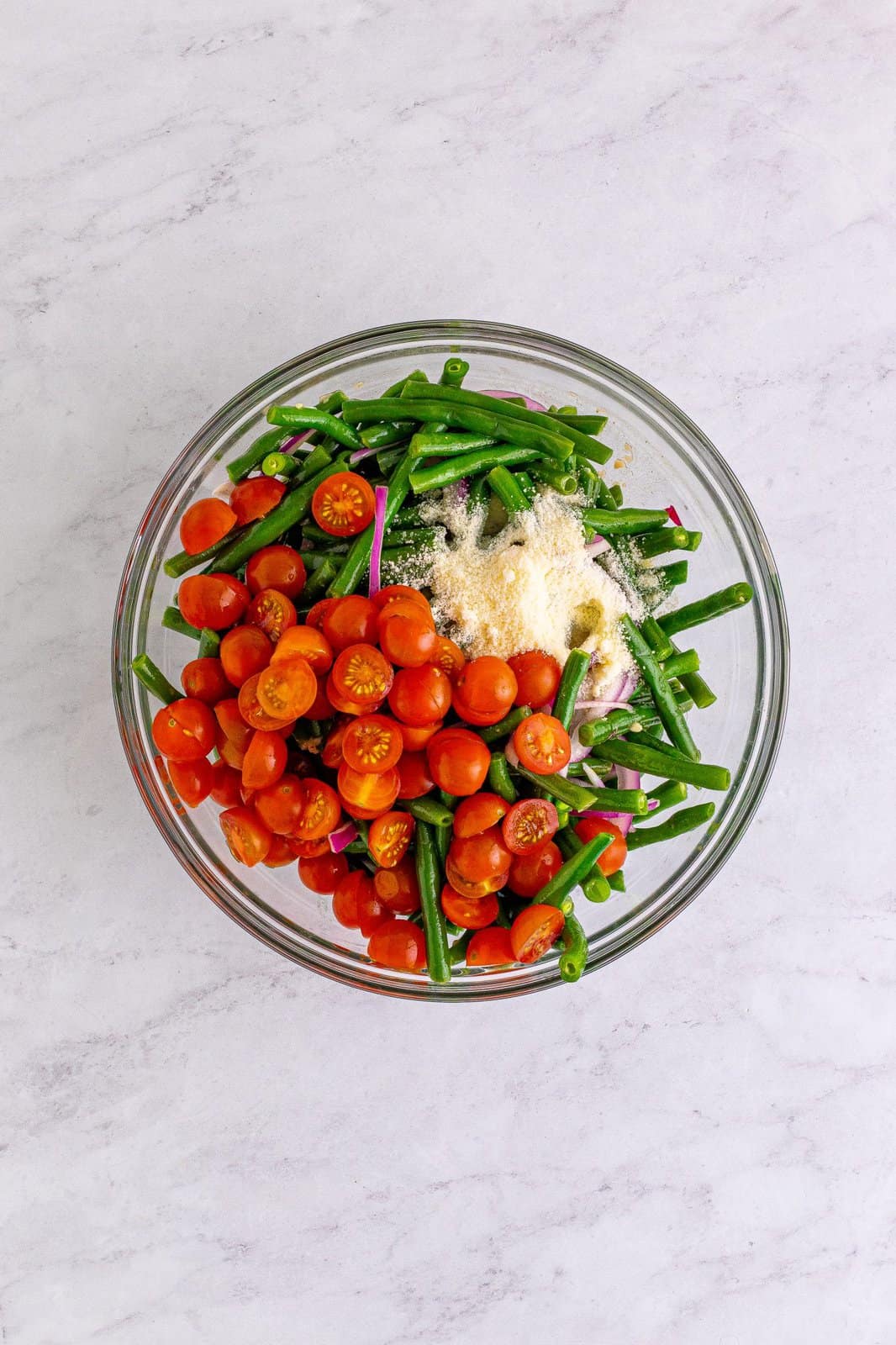 Tomatoes and cheese added to the green beans after chilling.