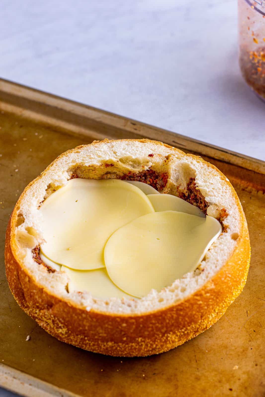 Provolone cheese layered over the olive spread.