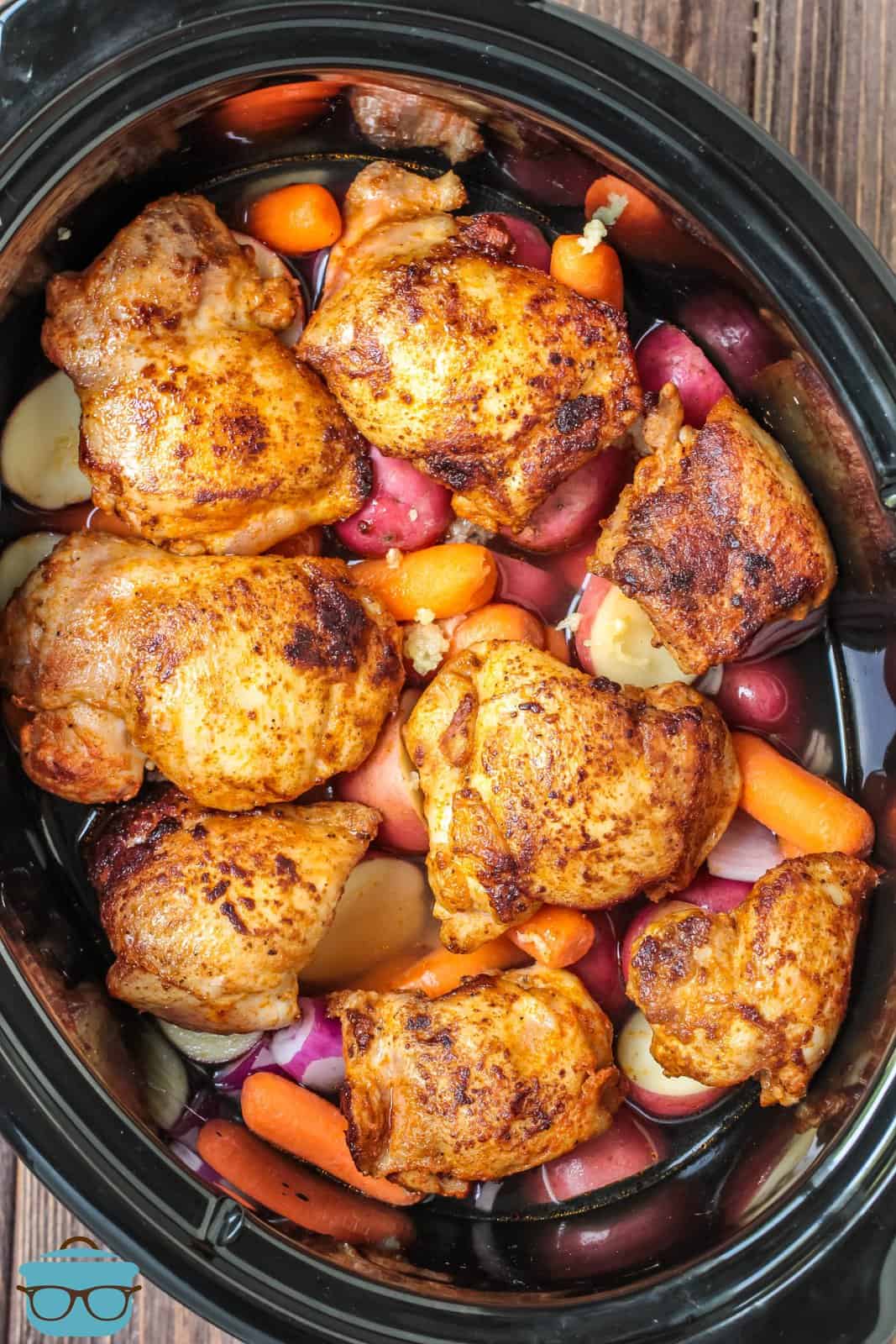 Chicken added to top of vegetables with stock added.