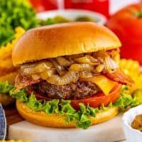 Close up square image of one Grilled Bacon Cheeseburgers with Coca Cola Onions.