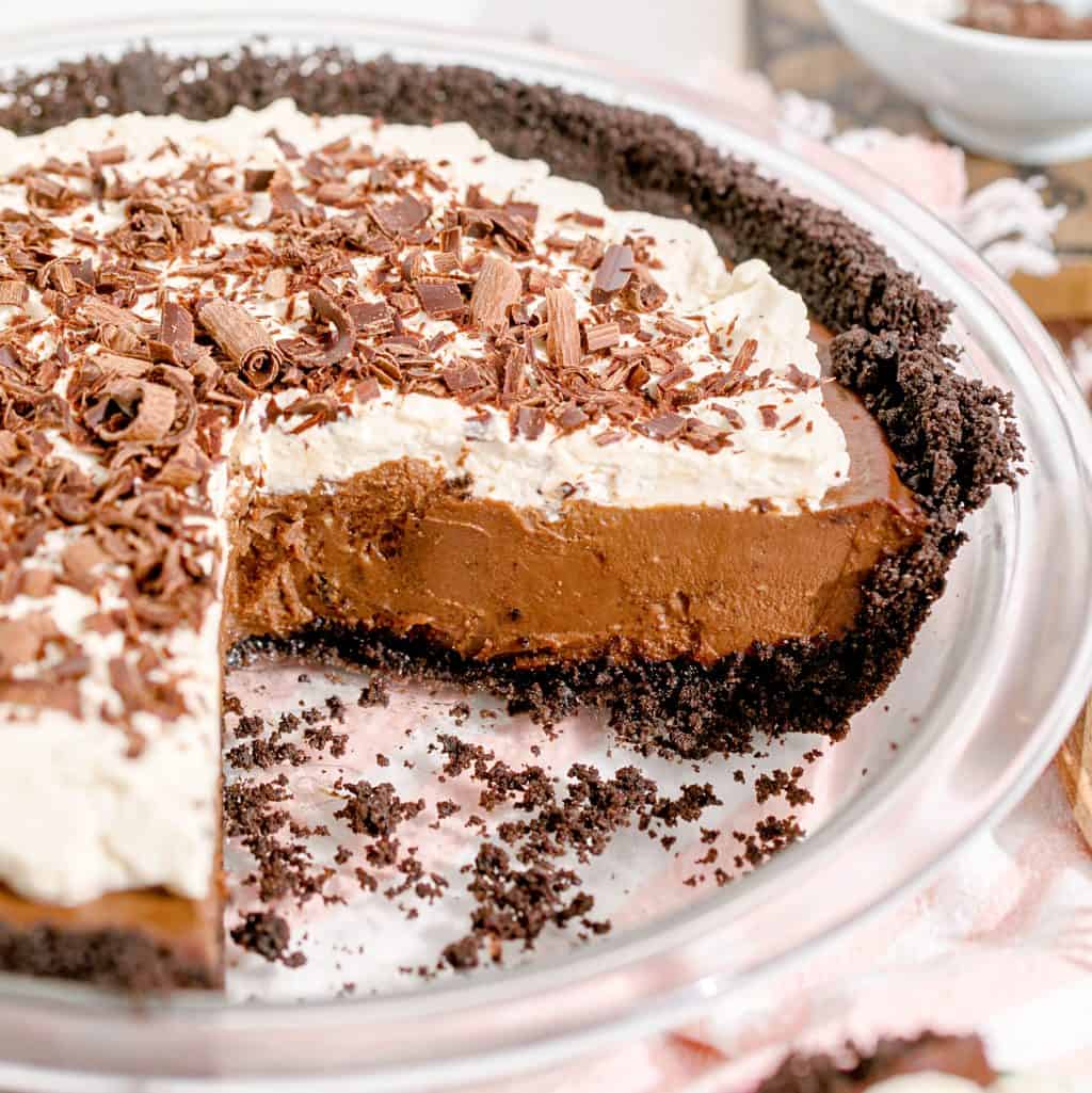 Square image of Chocolate Cream Pie with slices removed showing the filling.