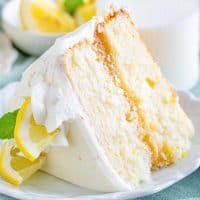 Close up square image of slice of Lemon Layer Cake on white plate.
